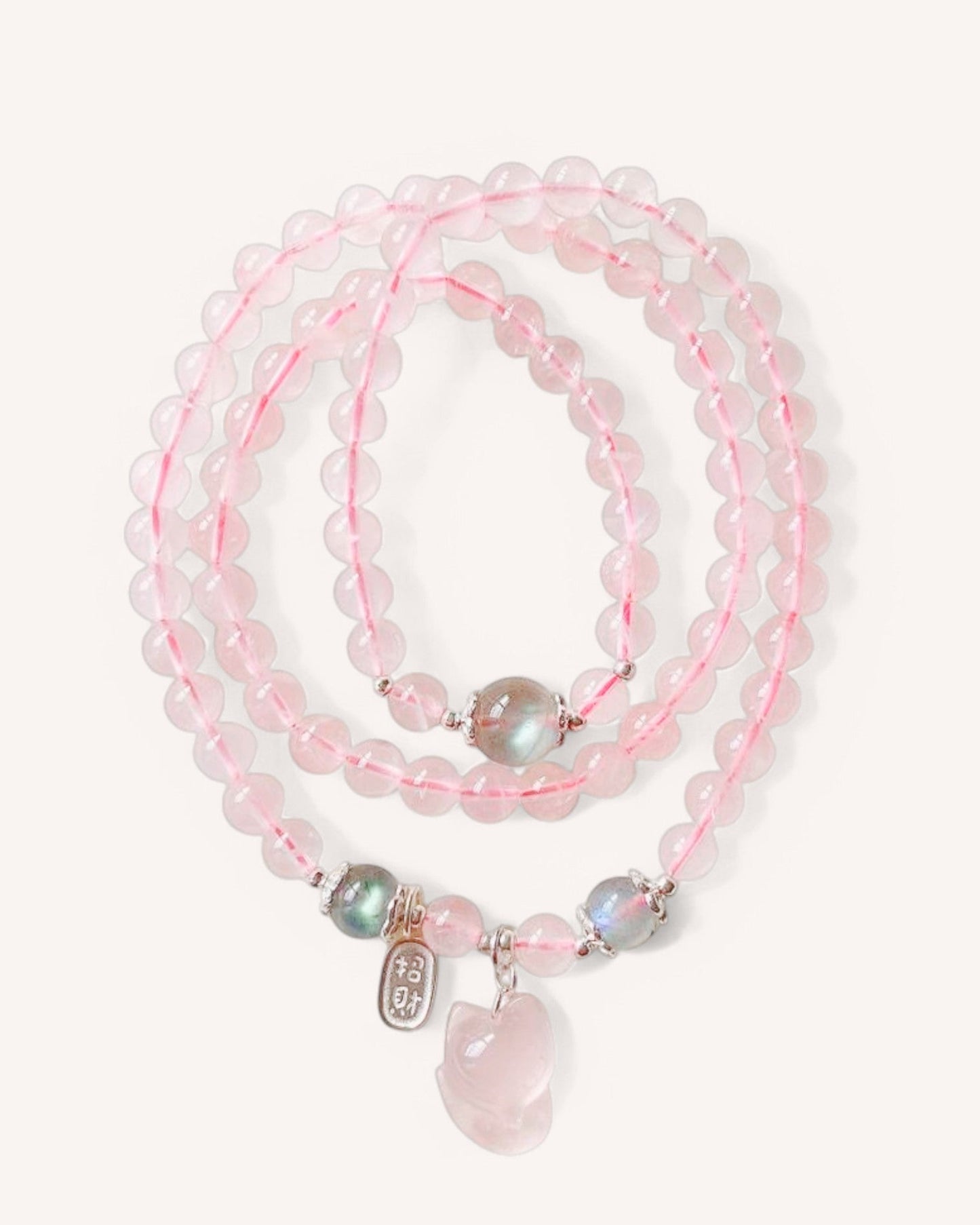 Close-up of Rose Quartz and Moonstone wrap bracelet with silver accents, showcasing love and intuition healing energy