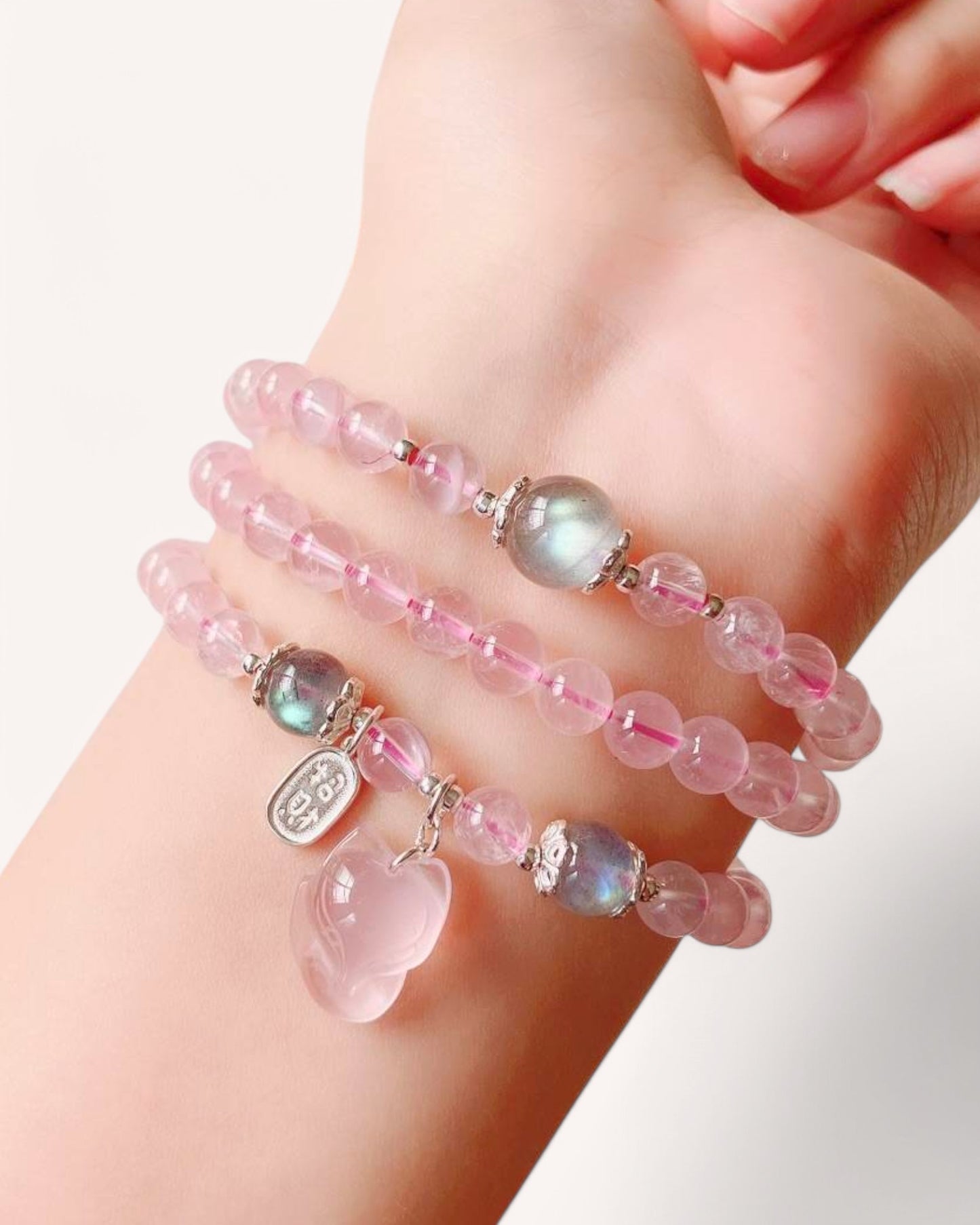Rose Quartz and Moonstone wrap bracelet worn on wrist, promoting love, serenity and inner harmony