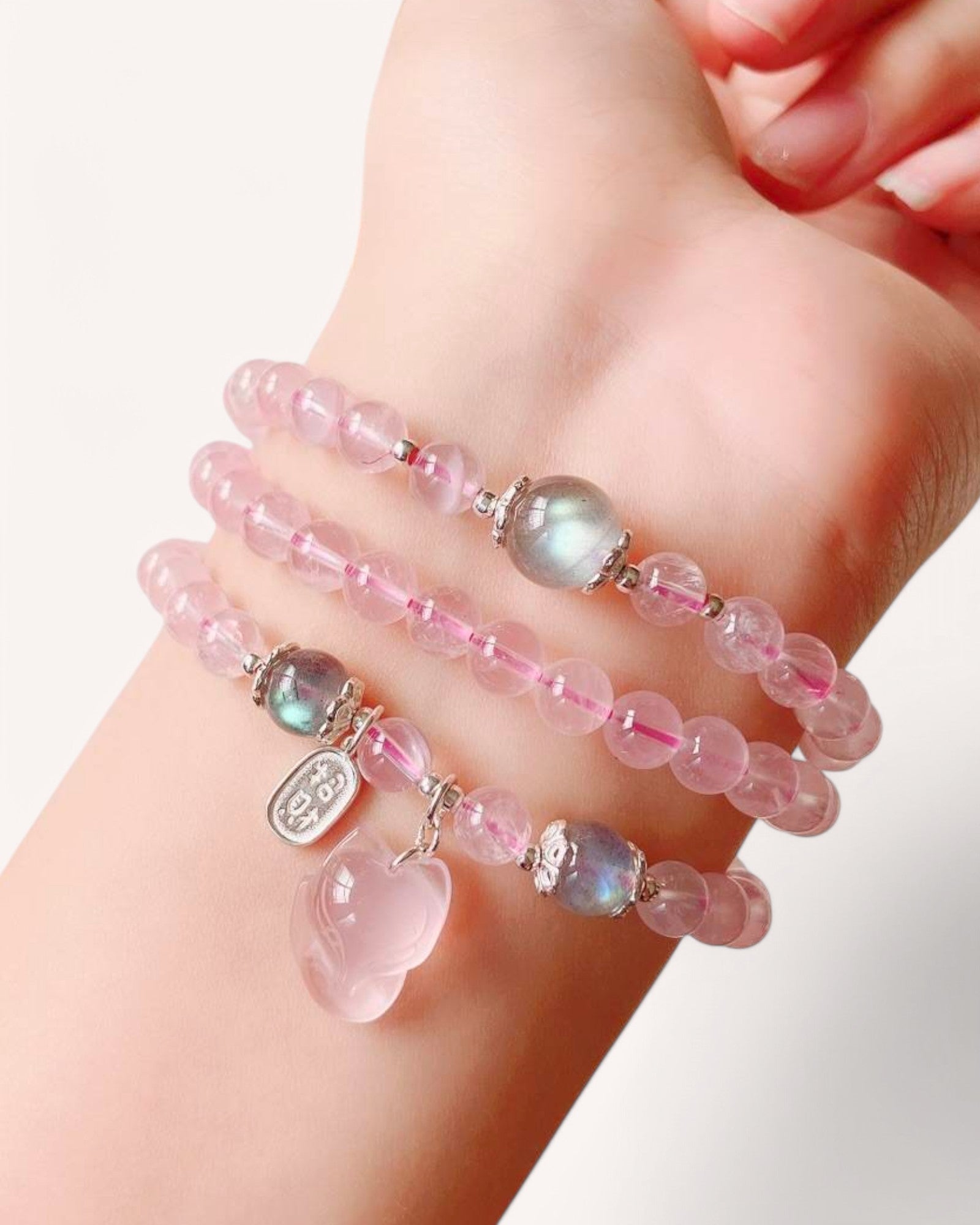 Rose Quartz and Moonstone wrap bracelet worn on wrist, promoting love, serenity and inner harmony