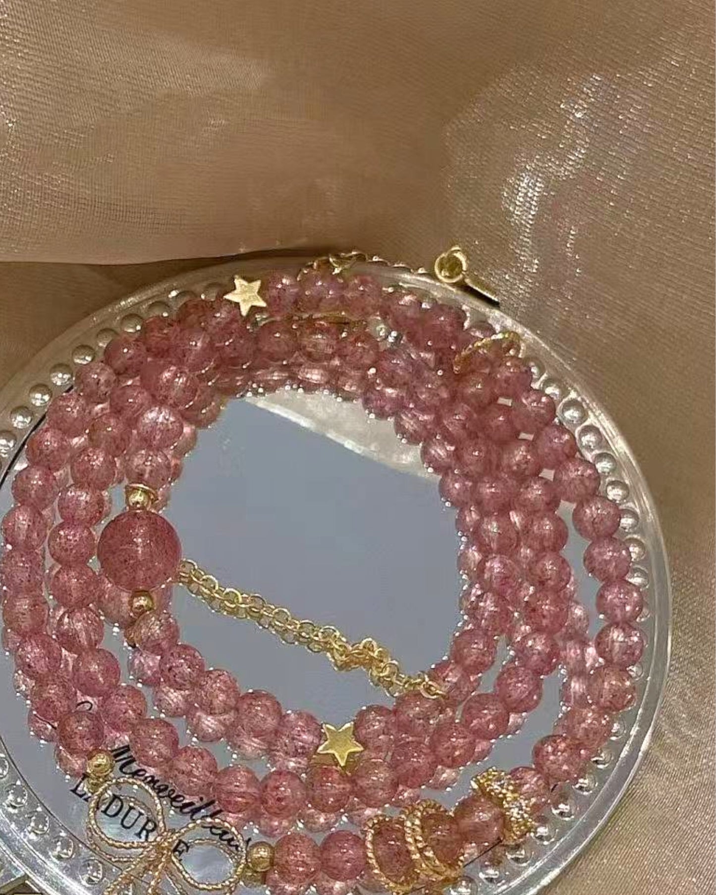 Multi-layer Strawberry Quartz bracelet with 14K gold-plated accents displayed in gift packaging, symbolizing love and emotional healing.