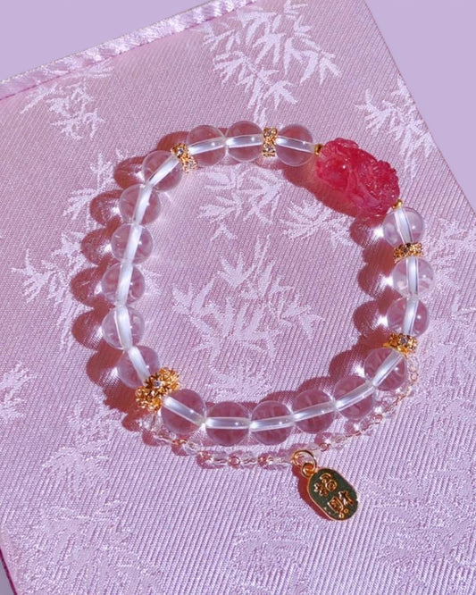  Strawberry Quartz & White Quartz Pixiu Bracelet, symbolizing love, wealth, and emotional healing, elegantly placed on a soft pink fabric background.