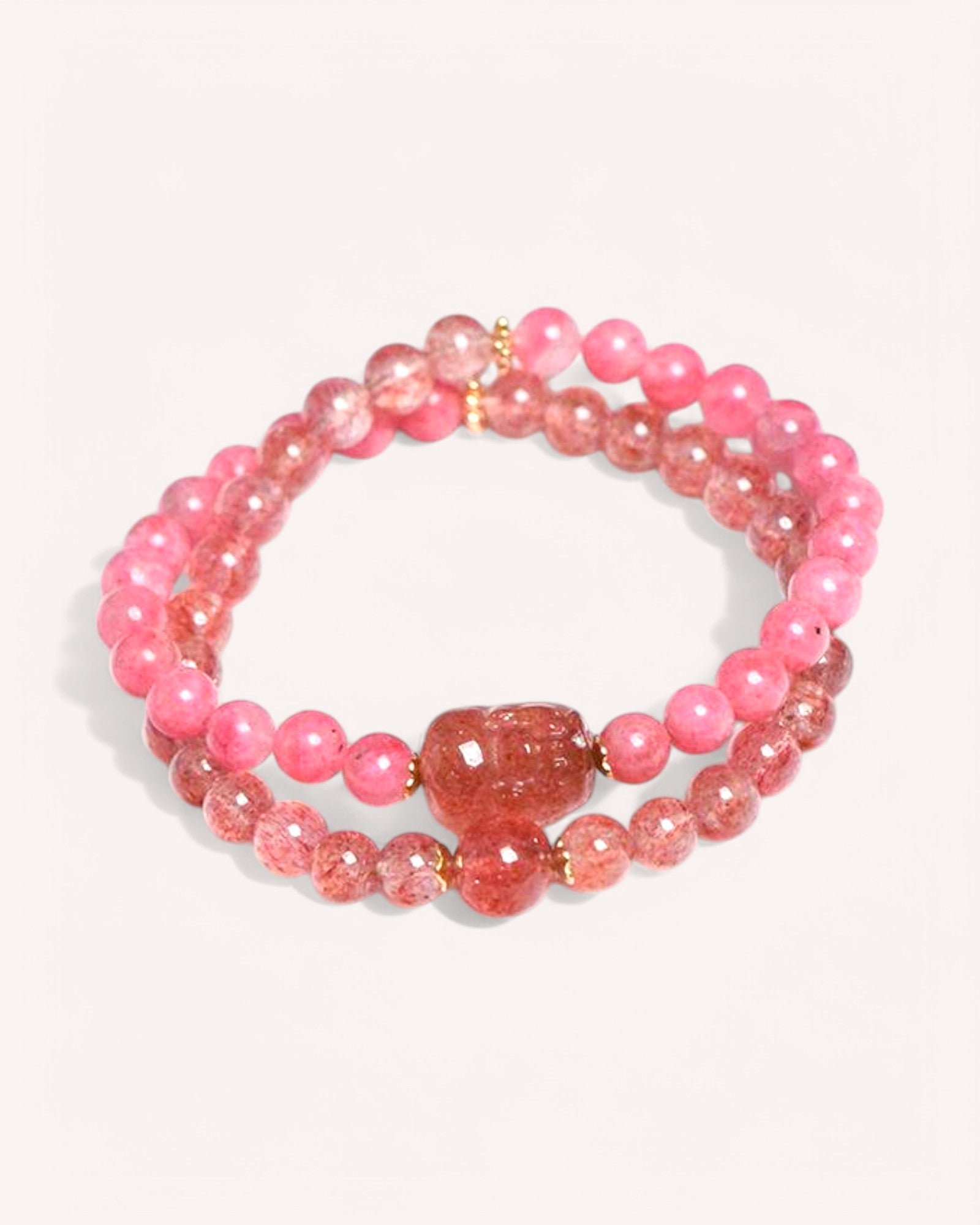 Close-up of multi-strand Strawberry Quartz & Rhodonite bracelet enhancing emotional balance and self-love.