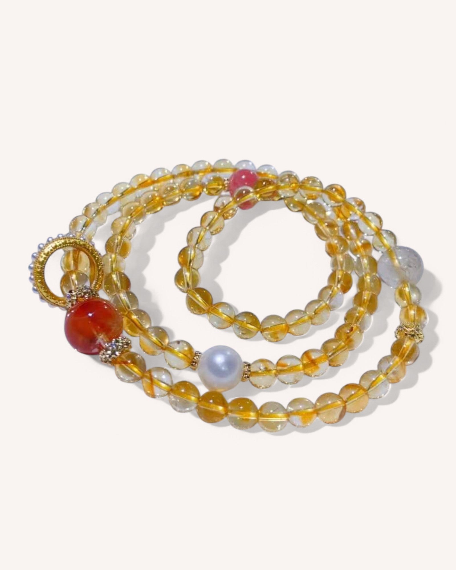 Wealth Manifestation Citrine Multi-Layer Bracelet – A high-energy spiritual bracelet crafted with Citrine, Golden Rutilated Quartz, Pearl, and Rhodochrosite to amplify prosperity, self-love, and motivation.