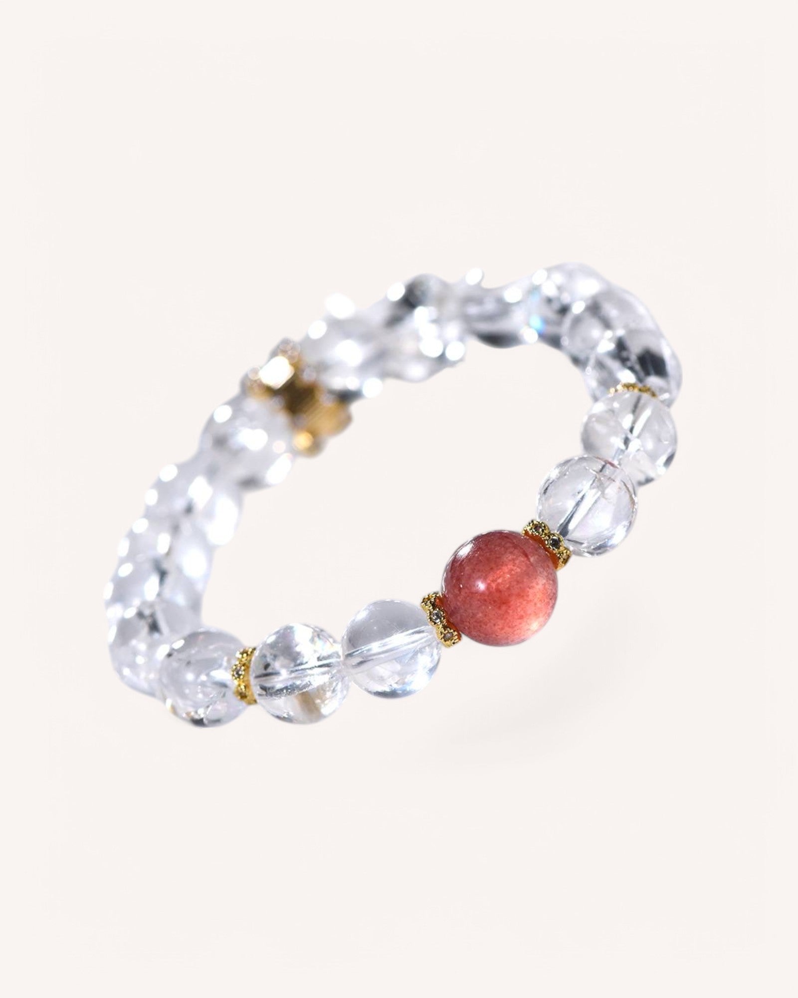 Side-angle view of the White Azeztulite & Strawberry Quartz Bracelet. A high-vibration energy piece for clarity, intuition, and positivity with luxurious 14K gold accents.