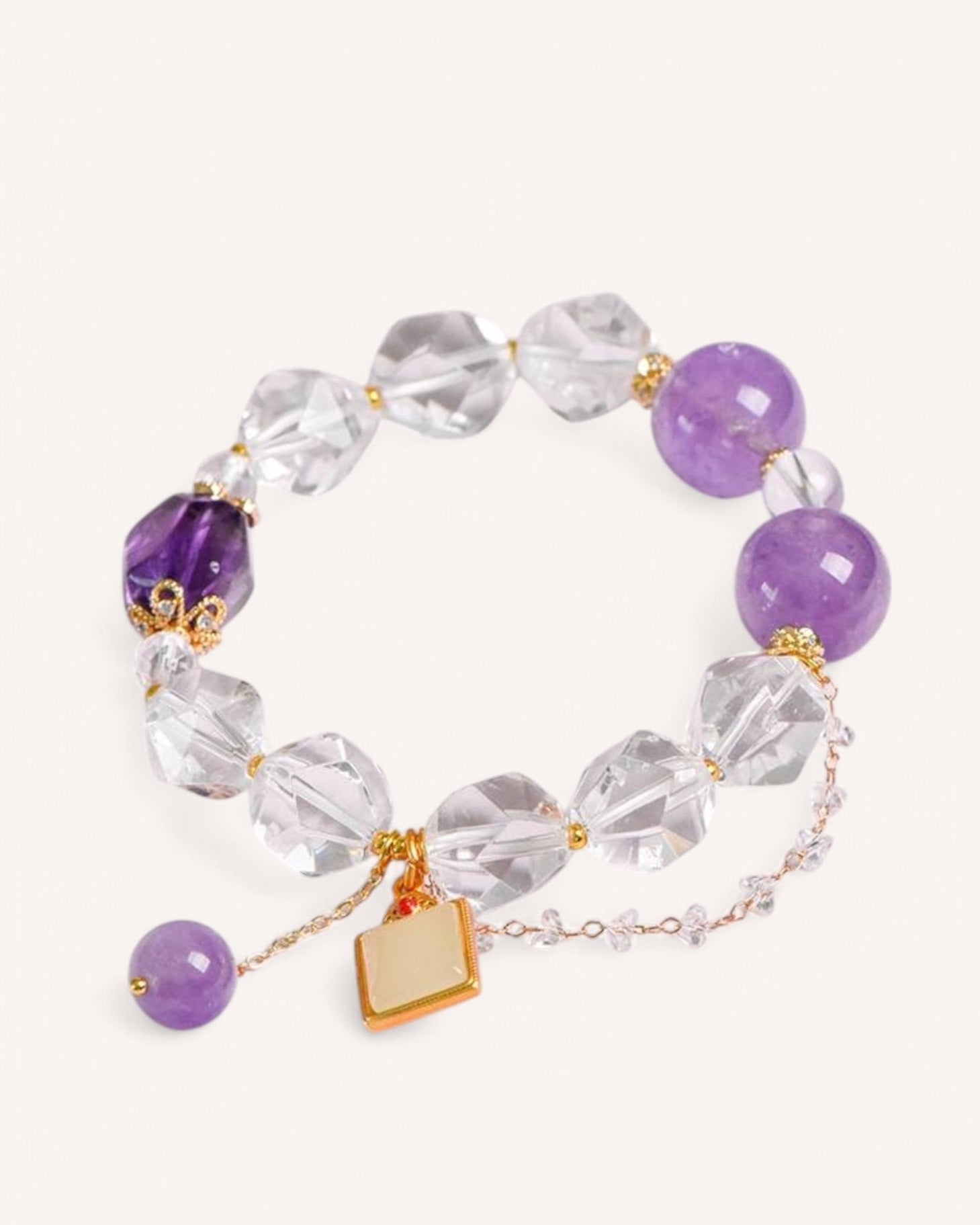 Close-up of White Quartz & Lavender Amethyst Bracelet featuring faceted white quartz and amethyst beads, symbolizing clarity, prosperity, and spiritual balance.