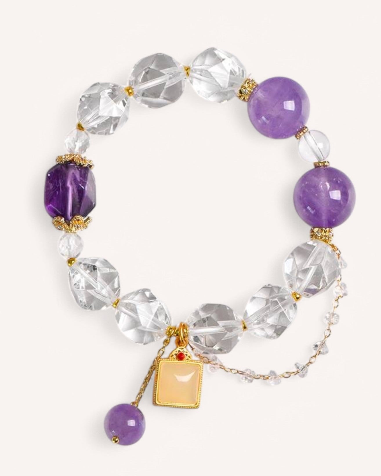 Top view of White Quartz & Lavender Amethyst Bracelet, showcasing its elegant faceted crystal design and gold-accented charms for abundance and harmony.