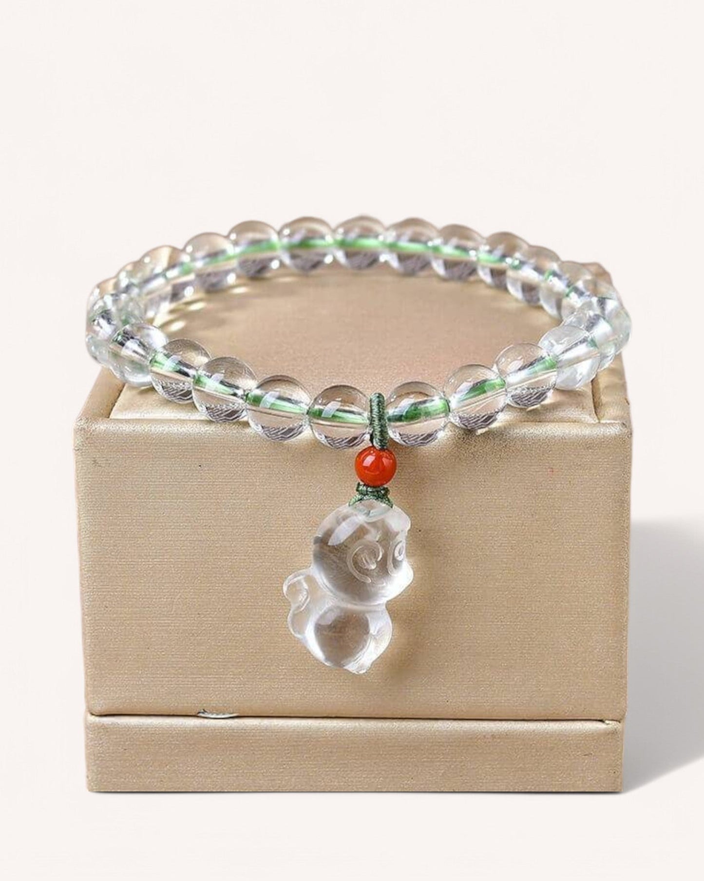 Elegant White Quartz Zodiac Monkey Bracelet displayed on a box, highlighting its energy-enhancing properties for wisdom, adaptability, and confidence.
